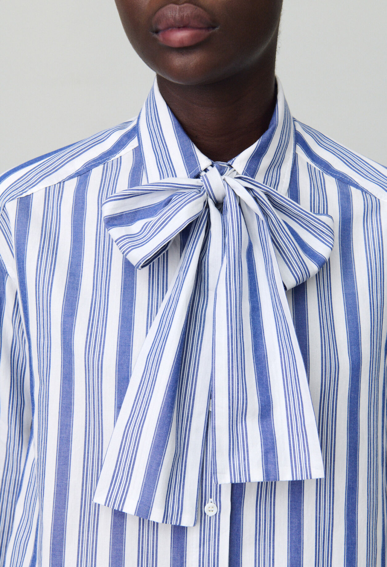 Striped shirt with bow collar