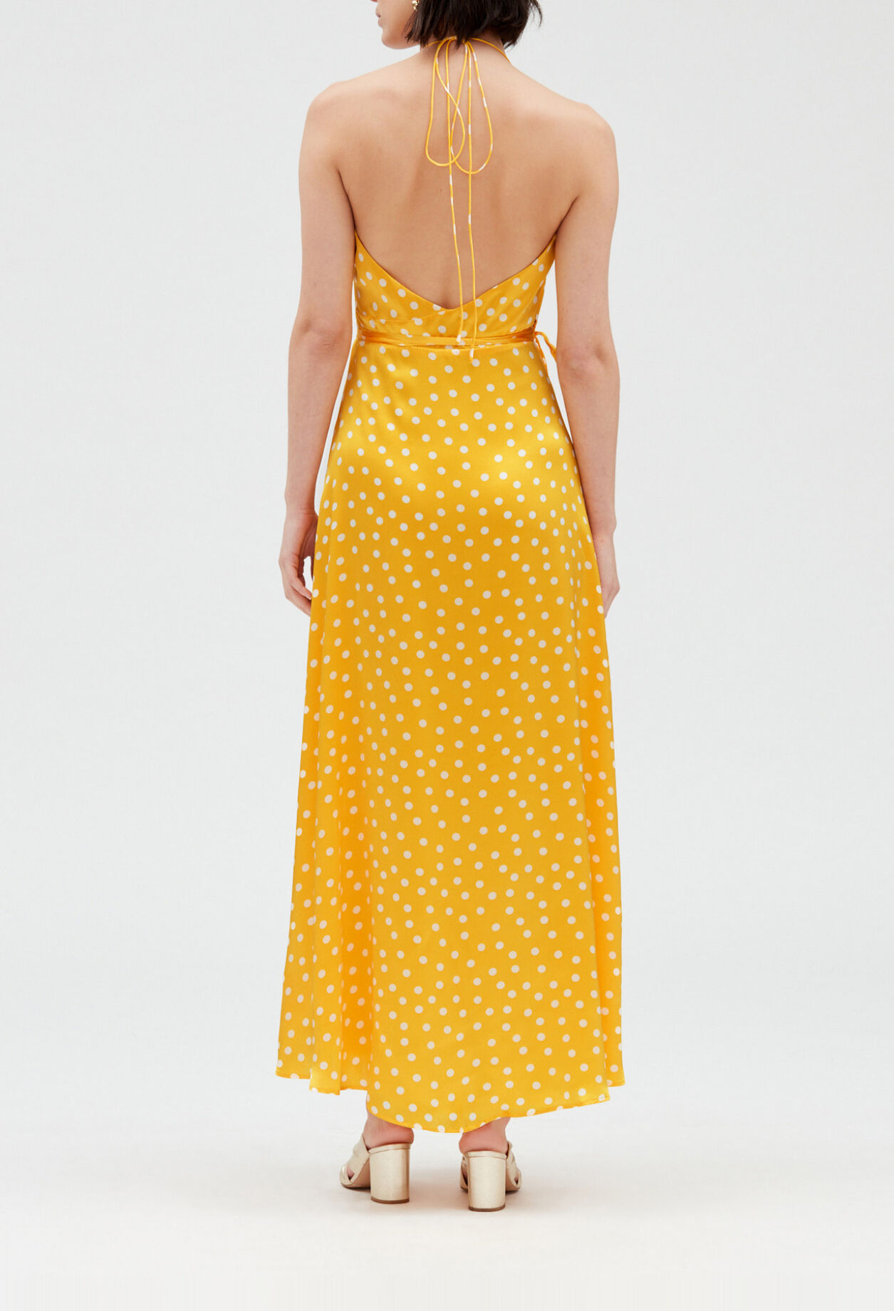 Long yellow silk wraparound dress.
